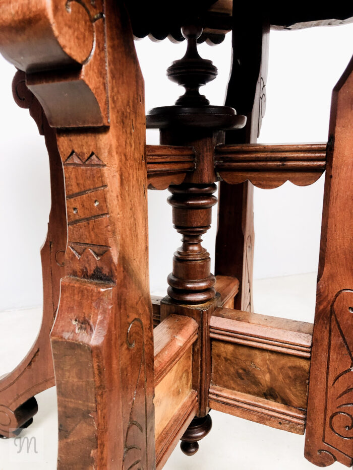 Steeped in history and handcrafted charm, this antique Eastlake parlor table, circa 1890, invites timeless sophistication into your home. Constructed from rich solid sapele mahogany and warm walnut,